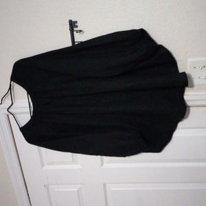 Black blouse curvature hem in front longer in the back.